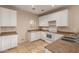 Kitchen features white appliances, ample counter space, tile flooring and plenty of room to move around at 6337 W Valencia Dr, Laveen, AZ 85339