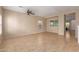 Spacious living room with tiled floors, neutral walls, ceiling fan, and abundant natural light from the windows at 6337 W Valencia Dr, Laveen, AZ 85339