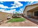 Spacious backyard featuring a trampoline, covered patio, and gravel area, ideal for outdoor activities at 6638 W Nez Perce St, Phoenix, AZ 85043