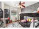 Charming bedroom featuring a ceiling fan, a bunk bed, and a window with natural lighting at 6638 W Nez Perce St, Phoenix, AZ 85043