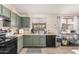 Functional kitchen with dark green cabinetry and modern appliances at 6638 W Nez Perce St, Phoenix, AZ 85043