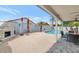 Outdoor living area with fireplace, dining, pool, mature landscaping, and spacious patio, perfect for relaxing at 6915 E Lakeview Ave, Mesa, AZ 85209