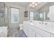 Bright bathroom with double sinks, framed mirrors, walk-in shower, and tile flooring at 6915 E Lakeview Ave, Mesa, AZ 85209