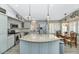 Modern kitchen featuring stainless steel appliances, a granite island, and stylish pendant lighting at 6915 E Lakeview Ave, Mesa, AZ 85209