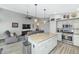 Open kitchen with granite countertops and stainless steel appliances flows into the living room at 6915 E Lakeview Ave, Mesa, AZ 85209