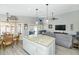 Open kitchen with an island bar, stainless steel appliances, and sliding doors leading to a patio area at 6915 E Lakeview Ave, Mesa, AZ 85209