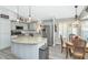 Well-lit kitchen with stainless steel appliances and a granite island, complemented by a cozy breakfast nook at 6915 E Lakeview Ave, Mesa, AZ 85209