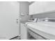 Clean and functional laundry room with modern, white appliances and plenty of storage space at 6915 E Lakeview Ave, Mesa, AZ 85209