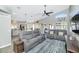 Living room with view of outdoor patio through large windows, features modern furniture at 6915 E Lakeview Ave, Mesa, AZ 85209
