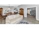 Open-concept living area featuring elegant wood flooring, a formal dining area, and comfortable seating at 6915 E Lakeview Ave, Mesa, AZ 85209