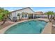 Inviting backyard with a private pool, palm trees, and covered patio, perfect for outdoor entertaining at 6915 E Lakeview Ave, Mesa, AZ 85209