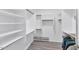 Walk-in closet with multiple storage shelves and rods for organization at 6915 E Lakeview Ave, Mesa, AZ 85209