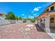 Rock landscaping backyard features a covered patio providing shade and great views at 6928 W Oraibi Dr, Glendale, AZ 85308
