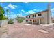 Wide-angle of two story home and backyard with covered patio and rock landscaping at 6928 W Oraibi Dr, Glendale, AZ 85308
