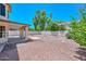 Large backyard with a covered patio, rock landscaping, and views, ideal for relaxation and entertainment at 6928 W Oraibi Dr, Glendale, AZ 85308