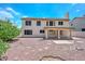 Two-story home backyard featuring red rock landscaping, covered patio, and privacy at 6928 W Oraibi Dr, Glendale, AZ 85308