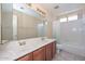 The bathroom features dual sinks, vanity with generous counter space, and a shower and tub combo at 6928 W Oraibi Dr, Glendale, AZ 85308