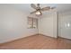 This airy bedroom features a closet, ceiling fan, and wood laminate flooring at 6928 W Oraibi Dr, Glendale, AZ 85308