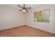 This cozy bedroom offers wood laminate flooring and a ceiling fan for added comfort at 6928 W Oraibi Dr, Glendale, AZ 85308