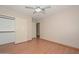 This bedroom features wood laminate flooring, closet space and bright lighting at 6928 W Oraibi Dr, Glendale, AZ 85308