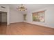 Open bedroom has neutral walls, light wood floors, ceiling fan, and natural light through windows making it a cozy retreat at 6928 W Oraibi Dr, Glendale, AZ 85308