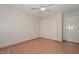 This bedroom features wood laminate flooring and a closet for storage at 6928 W Oraibi Dr, Glendale, AZ 85308