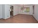 Open dining room with laminate flooring, natural light, and traditional chandelier at 6928 W Oraibi Dr, Glendale, AZ 85308