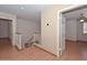 Upstairs hallway with wood floors, white railings, and multiple entryways at 6928 W Oraibi Dr, Glendale, AZ 85308