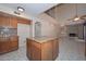 Bright kitchen featuring granite countertops, wooden cabinets, and an open view to living room at 6928 W Oraibi Dr, Glendale, AZ 85308