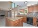 Open kitchen offers granite counters, island, and a seamless transition to the living space at 6928 W Oraibi Dr, Glendale, AZ 85308
