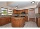 Charming kitchen with granite countertops, a central island, and ample cabinet space at 6928 W Oraibi Dr, Glendale, AZ 85308