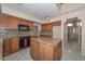 This kitchen features wooden cabinets, granite countertops, and an island with storage at 6928 W Oraibi Dr, Glendale, AZ 85308