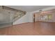 Spacious living room with laminate flooring, staircase, and a traditional chandelier at 6928 W Oraibi Dr, Glendale, AZ 85308