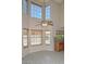 Bright living room with large windows and high ceilings adjacent to the kitchen at 6928 W Oraibi Dr, Glendale, AZ 85308