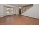 Bright living room featuring laminate floors, large windows, and a smooth ceiling at 6928 W Oraibi Dr, Glendale, AZ 85308