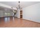 Open-concept living area featuring laminate floors and a smooth ceiling at 6928 W Oraibi Dr, Glendale, AZ 85308
