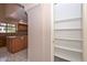View of walk-in pantry with many shelves near the kitchen at 6928 W Oraibi Dr, Glendale, AZ 85308