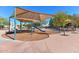 Shaded community playground with slide and climbing structure on soft ground for safe play at 6928 W Oraibi Dr, Glendale, AZ 85308