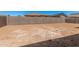 View of the property's unlandscaped backyard with concrete block perimeter wall at 6952 E Brushy Bill Rd, San Tan Valley, AZ 85143