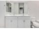 A bright bathroom has a double vanity, large mirrors, and a toilet in a modern home at 6952 E Brushy Bill Rd, San Tan Valley, AZ 85143