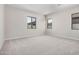A bedroom with neutral carpeting and natural light from multiple windows at 6952 E Brushy Bill Rd, San Tan Valley, AZ 85143