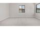 A bedroom with neutral carpeting, natural light, and a door leading to a walk-in closet at 6952 E Brushy Bill Rd, San Tan Valley, AZ 85143