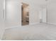 Spacious bedroom with neutral carpeting and a bathroom entry at 6952 E Brushy Bill Rd, San Tan Valley, AZ 85143