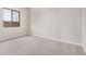 A neutral-toned bedroom has a carpeted floor, a window, and bright natural light at 6952 E Brushy Bill Rd, San Tan Valley, AZ 85143