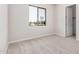 Bedroom with neutral carpeting, a window providing natural light, and a closet at 6952 E Brushy Bill Rd, San Tan Valley, AZ 85143