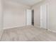A spacious bedroom features plush carpeting, neutral walls, and bright, natural light at 6952 E Brushy Bill Rd, San Tan Valley, AZ 85143