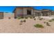 Attractive desert-landscaped front yard featuring low shrubs and a partial block wall at 6952 E Brushy Bill Rd, San Tan Valley, AZ 85143