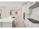 Bright kitchen with white cabinets, stainless steel appliances, and quartz countertops at 6952 E Brushy Bill Rd, San Tan Valley, AZ 85143