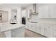 Bright kitchen with white cabinets, stainless steel appliances, and quartz countertops at 6952 E Brushy Bill Rd, San Tan Valley, AZ 85143