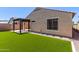 Landscaped backyard featuring artificial turf, a pergola, and rock landscaping at 7086 W Spur Dr, Peoria, AZ 85383
